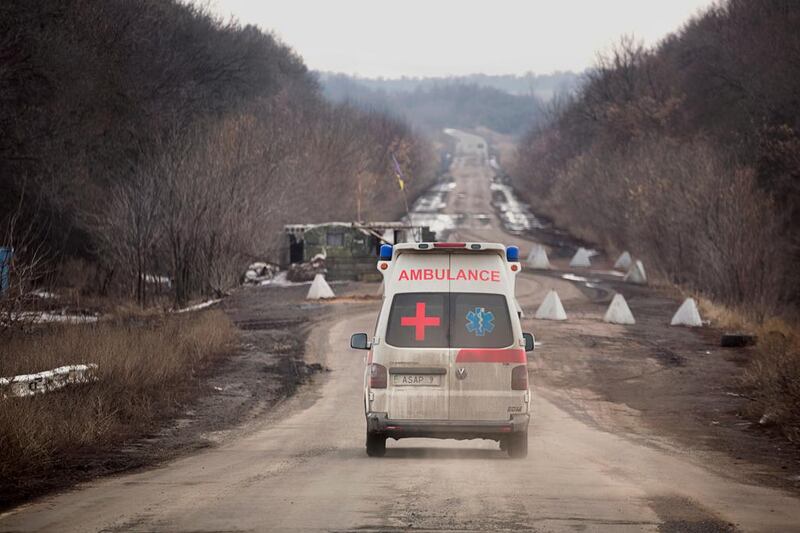 Volunteer paramedic Julia Paevska’s ambulance travels towards a Ukrainian army checkpoint on the road between Bakhmut and Luhanske, near the front line in Eastern Ukraine. Photo Alex Masi
