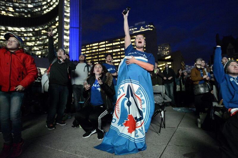 A Toronto Blue Jays fan cheers in Toronto’s Nathan Phillips Square as she watches the victorious fifth game of the ALDS against the Texas Rangers on Wednesday. Marta Iwanek / The Canadian Press / AP