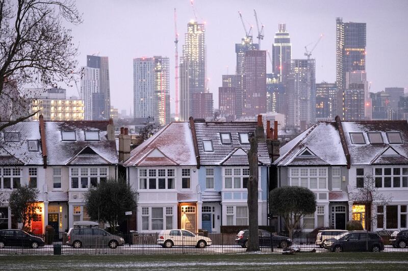 Snow-covered roofs and the glowing lights in the porches of south London Edwardian homes and residential high-rise towers under construction, on 8th February 2021, in London, England. (Photo by Richard Baker / In Pictures via Getty Images)