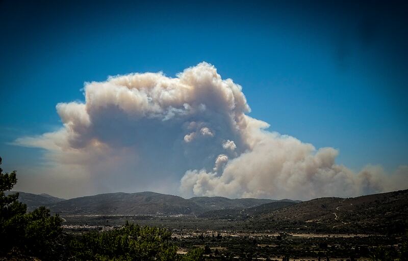 The smoke cloud from the forest fire rises over the island of Rhodes. AP