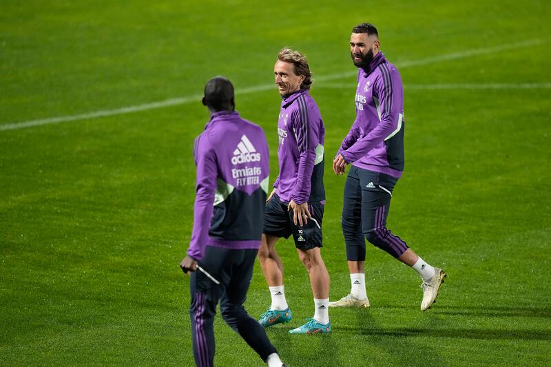 Real Madrid players Karim Benzema, right, and Luka Modric, centre, speaks with their teammate Antonio Rudiger during training. AP