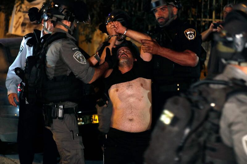 A Palestinian is detained by Israeli security forces during a protest. AFP