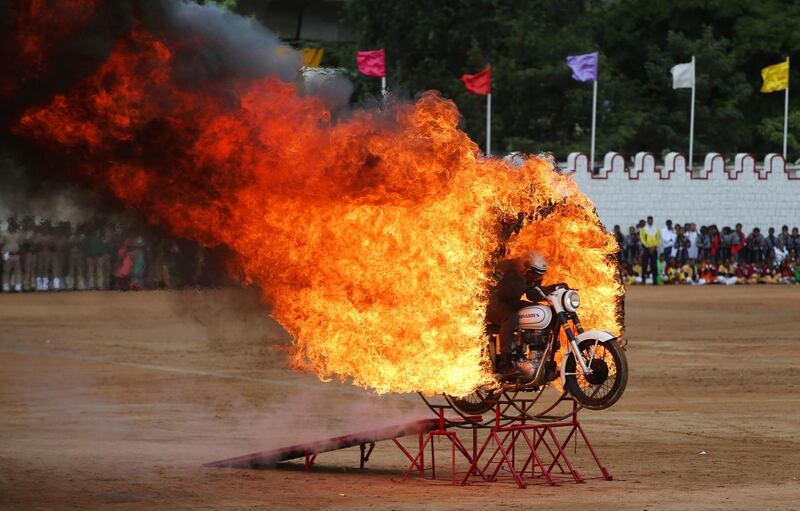 A member of ASC Tornados, the motorcycle display team of the Indian army, jumps through a ring of fire during Indian Independence Day celebrations in Bengaluru, India. Aijaz Rahi / AP Photo