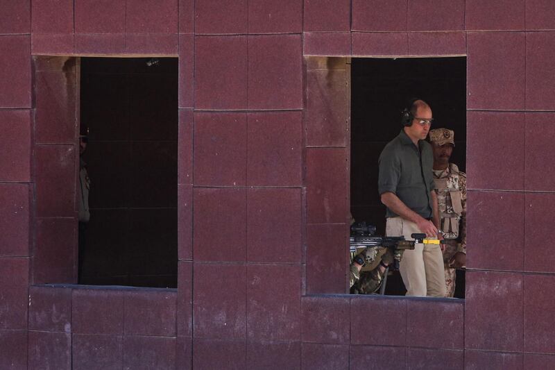 Prince William (C), Duke of Cambridge, is seen through the window of a building overseeing Kuwaiti and British soldiers taking part in the Exercise Desert Warrior at Sheikh Salem al-Ali al-Sabah Camp, about 40 kilometres north of Kuwait City.  AFP