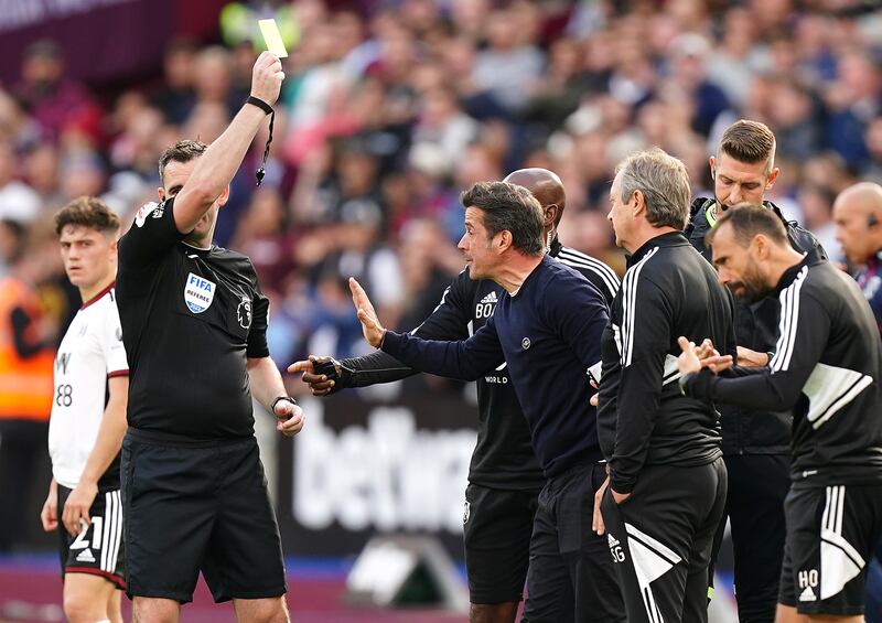 Fulham manager Marco Silva is shown a yellow card by referee Chris Kavanagh after Gianluca Scamacca's goal is allowed following a VAR check. PA