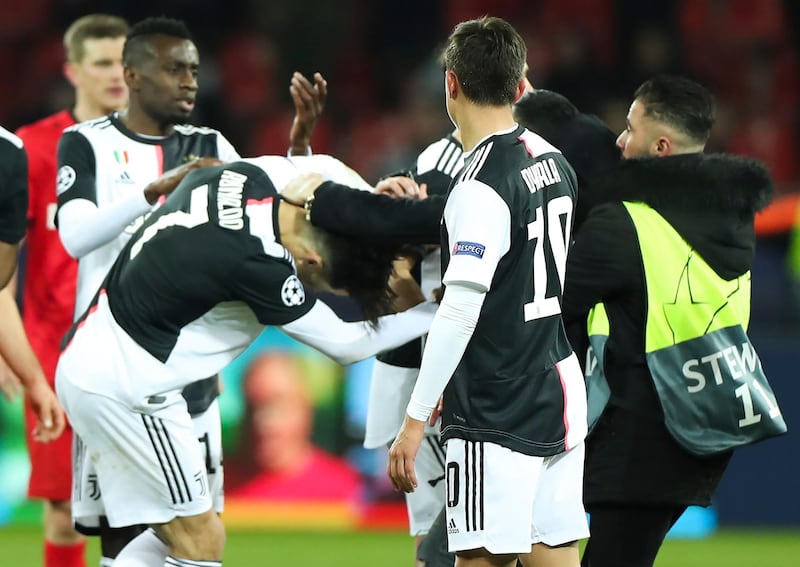 A pitch invader tries to hug an angry Cristiano Ronaldo (L) of Juventus. EPA