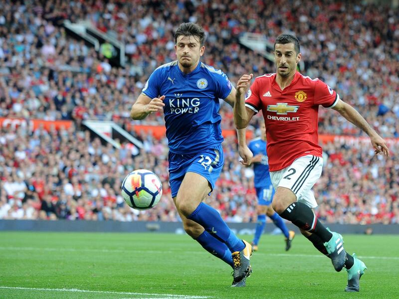 Manchester United's Henrikh Mkhitaryan, right, challenges Leicester's Harry Maguire, left, during the English Premier League soccer match between Manchester United and Leicester City at Old Trafford in Manchester, England, Saturday, Aug. 26, 2017. (AP Photo/Rui Vieira)