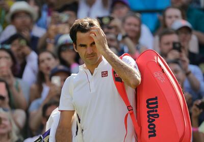 Switzerland's Roger Federer prepares to leave the court after losing his men's quarterfinals match against Kevin Anderson of South Africa, at the Wimbledon Tennis Championships, in London, Wednesday July 11, 2018. (AP Photo/Ben Curtis)