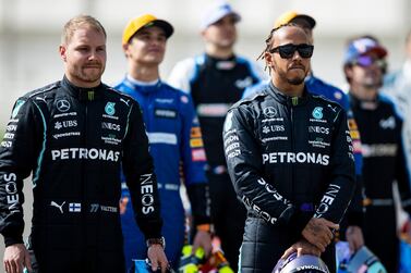 BAHRAIN, BAHRAIN - MARCH 12: Lewis Hamilton of Great Britain and Mercedes GP and Valtteri Bottas of Finland and Mercedes GP look on from the grid during Day One of F1 Testing at Bahrain International Circuit on March 12, 2021 in Bahrain, Bahrain. (Photo by Mark Thompson/Getty Images)