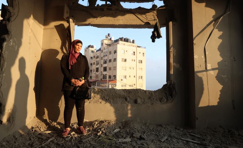 The sister of Palestinian prisoner Kamal Jouri inspects her room after it was destroyed during an overnight raid in the West Bank city of Nablus, on June 22. EPA