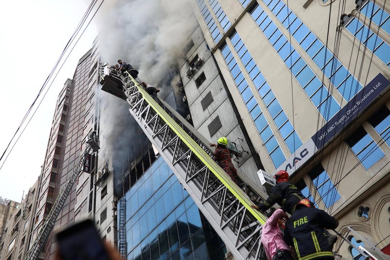 People are seen being rescued as fire broke out at a multi-storey commercial building in Dhaka. Reuters