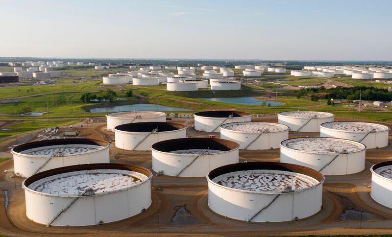 An aerial view of a crude oil storage facility is seen on May 4, 2020 in Cushing, Oklahoma. Using his fleet of drones, Dale Parrish tracks one of the most sensitive data points in the oil world: the amount of crude stored in giant steel tanks in Cushing, Oklahoma. The West Texas Intermediate oil stored in the small town in the midwestern United States is used as a reference price for crude bought and sold by refiners in Asia, hedge funds in London and traders in New York. / AFP / Johannes EISELE / TO GO WITH AFP STORY by Juliette MICHEL: "Cushing, Oklahoma: the town global oil markets depend on"
