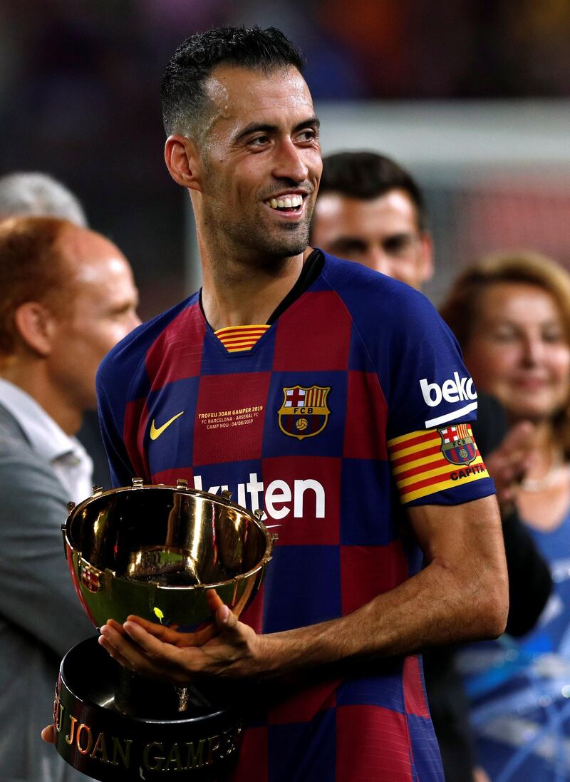 Barcelona's Sergio Busquets celebrates with the trophy at the end of the match. Reuters