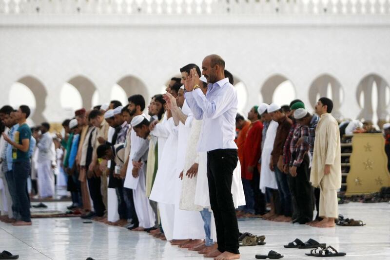 Muslims observe Eid prayers at the Sheikh Zayed Grand Mosque in Abu Dhabi. Christopher Pike / The National