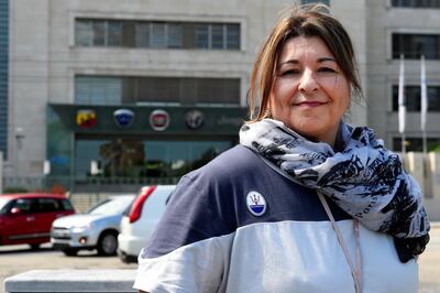 Fiat Chrysler Automobiles (FCA) worker Giovanna Treccalli poses at the entrance of the Mirafiori plant in Turin, Italy May 21, 2019. Picture taken May 21, 2019. REUTERS/Massimo Pinca