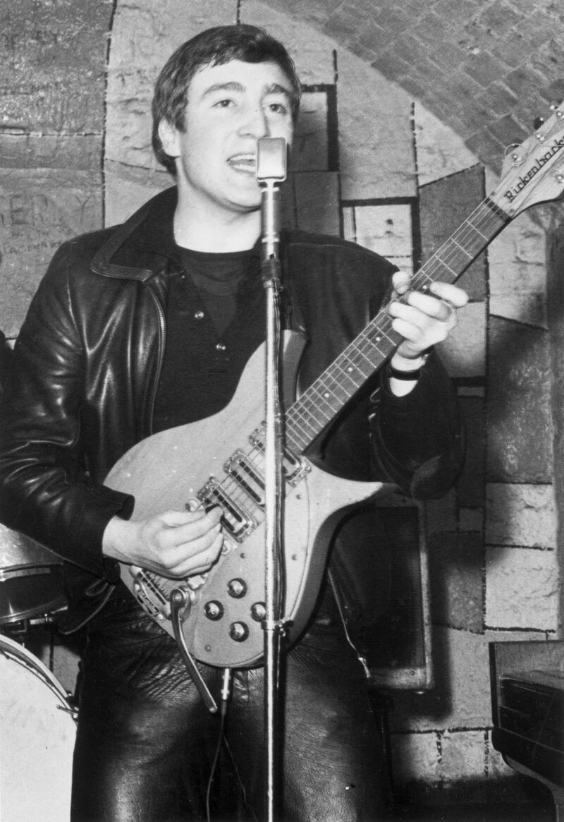 December 1961:  Singer, guitarist and songwriter John Lennon (1940 - 1980) of the British group The Beatles live on stage at the Cavern Club in Matthew Street, Liverpool.  (Photo by Evening Standard/Hulton Archive/Getty Images)