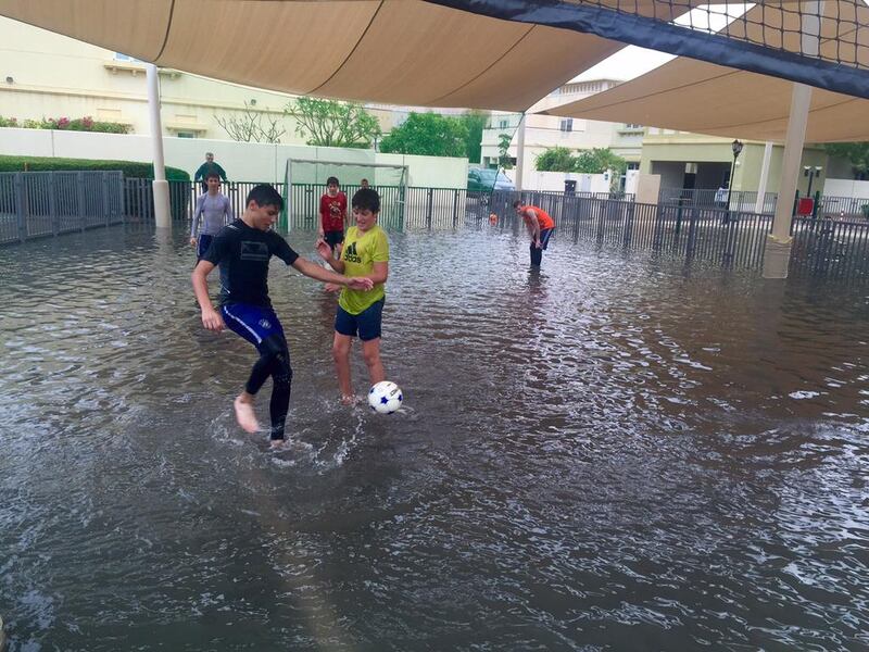 Children play football on a submerged pitch at The Lakes, Dubai. Courtesy Matt Slater