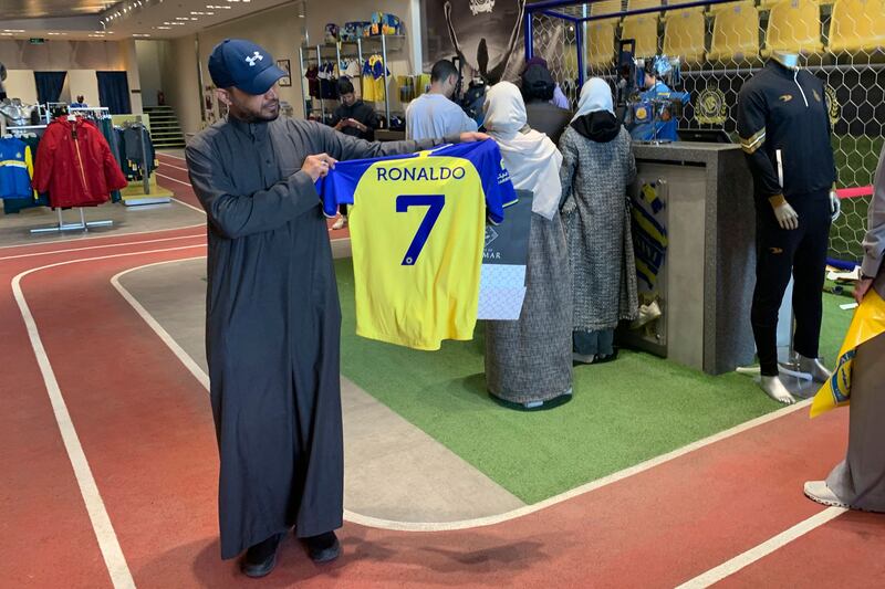 A fan holds a Cristiano Ronaldo jersey at Al Nassr club store in Riyadh. The Portugal star has signed a deal with the Saudi club that will run until June 2025. AFP