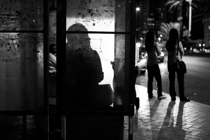 At the end of the evening workers in the downtown of Abu Dhabi await busses to make their way home. Brian Kerrigan / The National. 