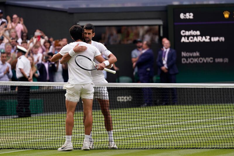 Spain's Carlos Alcaraz, front, embraces Serbia's Novak Djokovic after the final. AP 