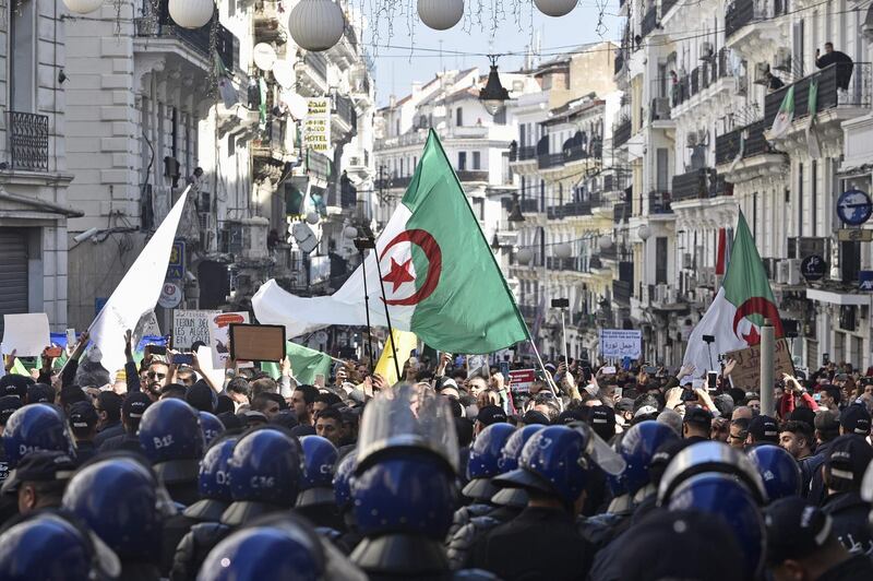 Algerian riot police block the progress of an anti-government demonstration heading towards the presidential palace in the capital Algiers.  AFP