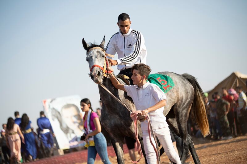 One of the jockeys with his assistant before a race