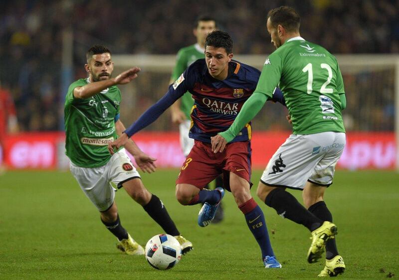 Barcelona’s Aitor Cantalapiedra tries to dribble through Villanovense players on Wednesday during their Copa del Rey round of 32 contest. Lluis Gene / AFP