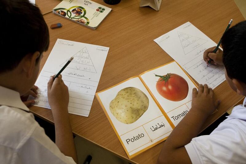 Students at Raha International School in Abu Dhabi learn Arabic from flash cards. An HSBC survey found that UAE parents typically only earmark 31 per cent of funds for their children’s needs to education, compared with the global average of 43 per cent. Andrew Henderson / The National

