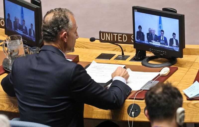 U.S. Deputy United Nations Ambassador Jonathan Cohen, left, address the U.N. Security Council after a report from U.N. chief mediator for Syria, Staffan de Mistura, shown center in a live video broadcast, Monday, Nov. 19, 2018 at U.N. headquarters. (AP Photo/Bebeto Matthews)