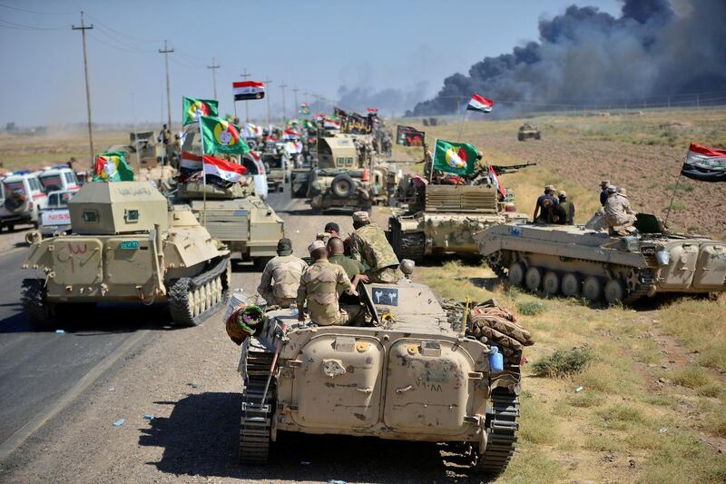 Shi'ite Popular Mobilization Forces (PMF) and Iraqi army members gather on the outskirts of Hawija, Iraq October 4, 2017. REUTERS/Stringer NO RESALES. NO ARCHIVES     TPX IMAGES OF THE DAY