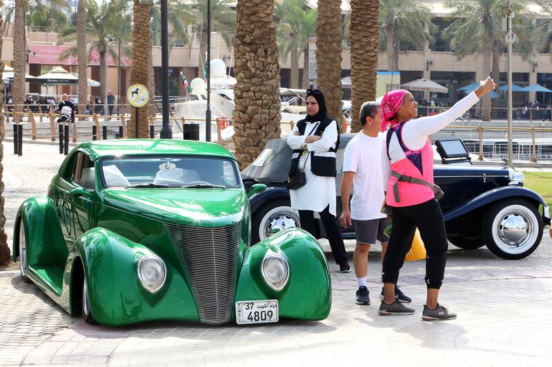 A woman takes a selfie with a 1937 Ford at a classic car show in Kuwait City. All photos by AFP