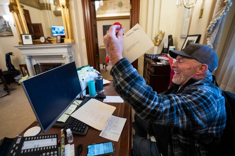 epa08923441 A supporter of US President Donald J. Trump sits on the desk of US House Speaker Nancy Pelosi, after supporters of US President Donald J. Trump breached the US Capitol security in Washington, DC, USA, 06 January 2021. Protesters stormed the US Capitol where the Electoral College vote certification for President-elect Joe Biden took place.  EPA/JIM LO SCALZO