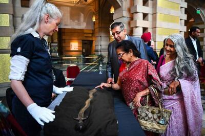 Guests look at the ceremonial Indo-Persian sword. AFP