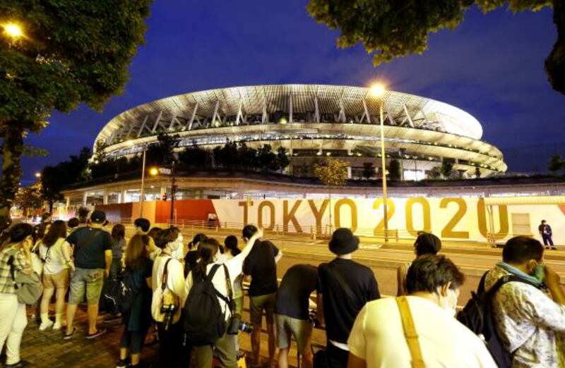 Supporters gather outside the National Stadium ahead of the Tokyo Olympic closing ceremony.