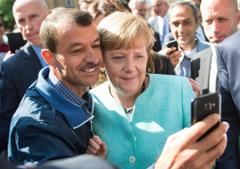 Angela Merkel. who was German chancellor at the time, poses for a selfie with a refugee in Berlin. AP.