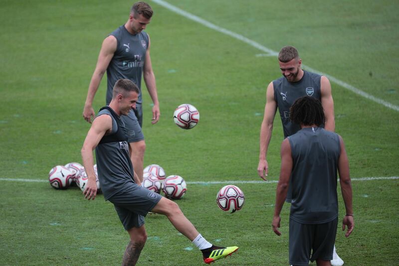 From left clockwise, Aaron Ramsey, Holding, Calum Chambers and Mohamed Elneny in action during a team training session. EPA