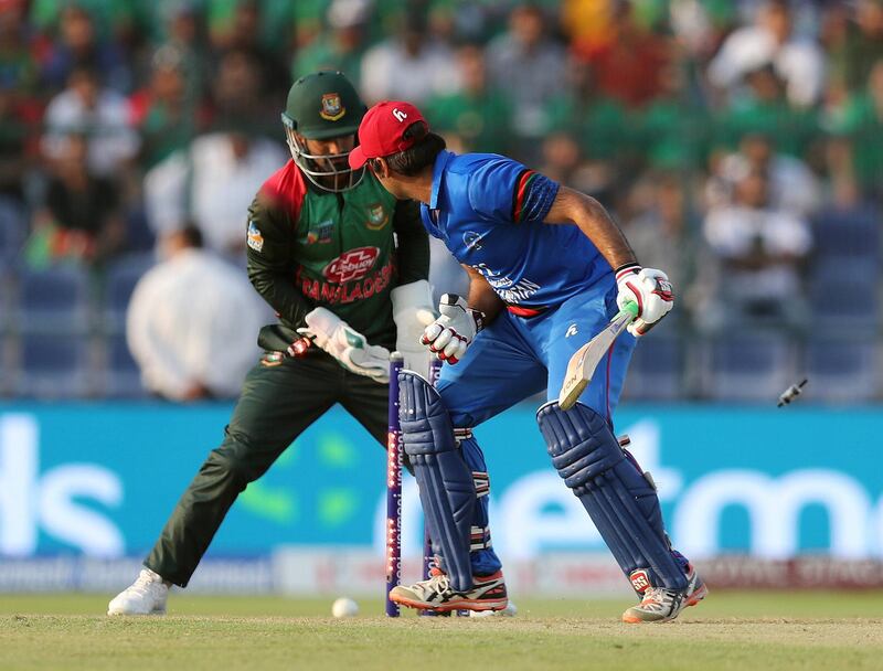 Abu Dhabi, United Arab Emirates - September 20, 2018: Bangladesh's Shakib Al Hasan (not in pic) takes the wicket of Afghanistan's Asghar Afghan (R) during the game between Bangladesh and Afghanistan in the Asia cup. Th, September 20th, 2018 at Zayed Cricket Stadium, Abu Dhabi. Chris Whiteoak / The National