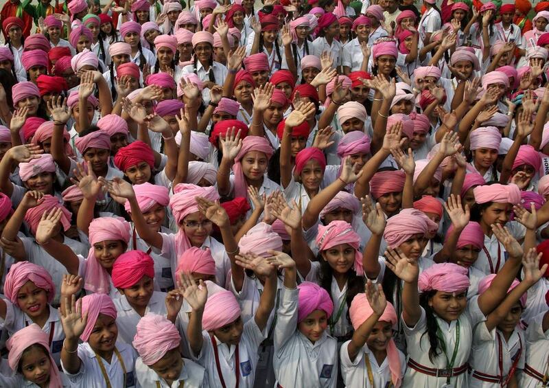 Girls wear turbans wave as they take part in celebrations to mark the ‘International Day of the Girl Child’ at a school premises in Chandigarh, India. Ajay Verma / Reuters