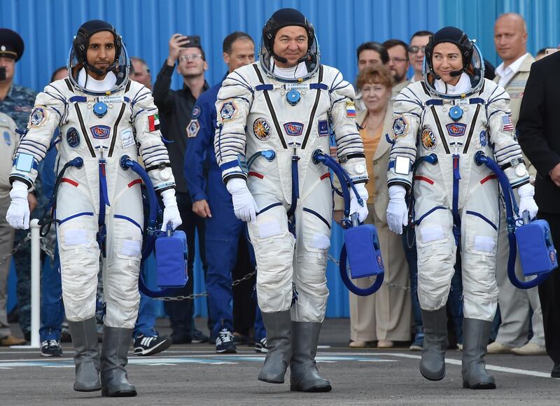 Sokol suit - Members of the main crew to the International Space Station (ISS) (from L) United Arab Emirates' astronaut Hazzaa al-Mansoori , Russian cosmonaut Oleg Skripochka and US astronaut Jessica Meir report to Roscosmos chief Dmitry Rogozin (R) arrive to board a Soyuz rocket to the ISS, at the Russian-leased Baikonur cosmodrome in Kazakhstan on September 25, 2019. (Photo by VYACHESLAV OSELEDKO / AFP)
