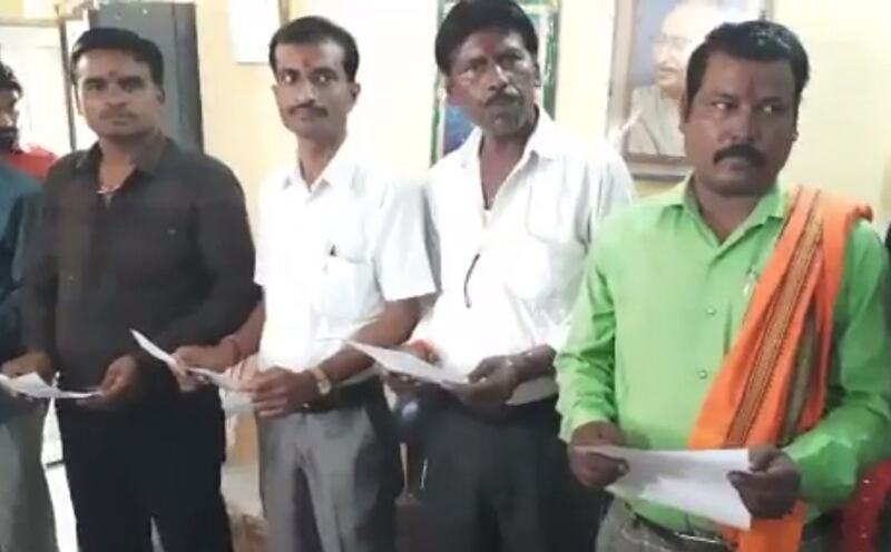 A screengrab from a video that shows men taking the oath of office on behalf of female village councillors in India. Twitter