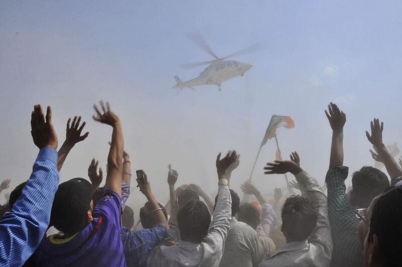 People wave towards a helicopter carrying Hindu nationalist Narendra Modi, the prime ministerial candidate for India’s main opposition Bharatiya Janata Party (BJP), after an election campaign rally at Mathura in the northern Indian state of Uttar Pradesh. K. K. Arora / Reuters