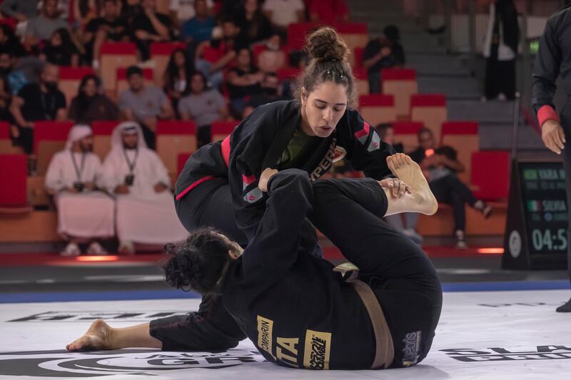 Yara Nascimento, top, during her win over Silvia Scomparin on Day 3 of the Jiu-Jitsu Abu Dhabi Grand Slam World Tour. Antonie Robertson/The National