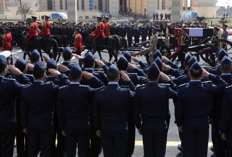 Officers salute as the coffin carrying  Mubarak passes by. EPA