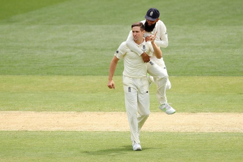 Chris Woakes celebrates with Moeen Ali after taking the wicket of Tim Paine during Day 4. Cameron Spencer / Getty Images