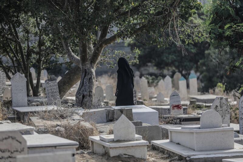 Palestinians visit the grave of their relatives in Gaza City. EPA