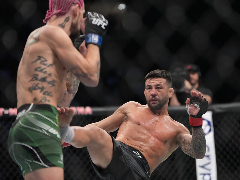 Pedro Munhoz lands a kick on Sean O'Malley at UFC 276. USA TODAY Sports