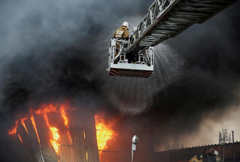 Firefighters work to extinguish a fire at a warehouse in Almaty, Kazakhstan. Reuters