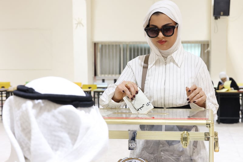 A Kuwaiti woman votes in parliamentary elections at a polling station in Kuwait City. AFP