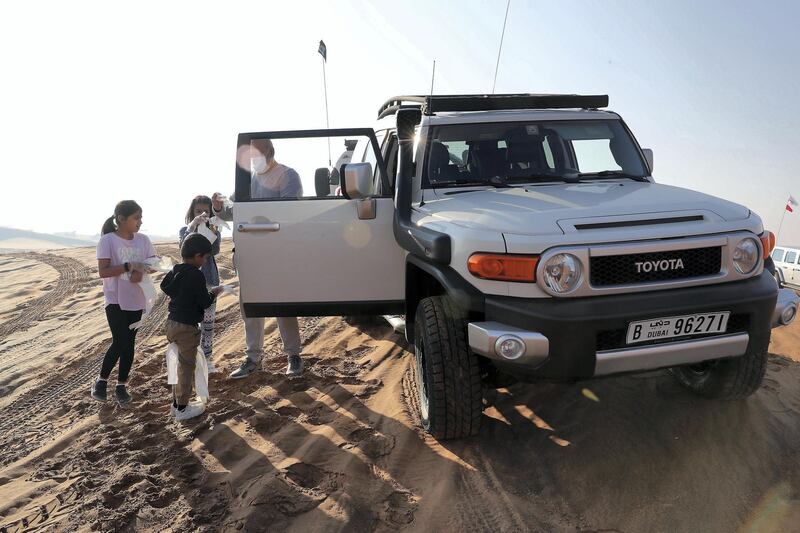 SHARJAH, UNITED ARAB EMIRATES , January 16– 2021 :- Members of the off roaders club collecting trash during the desert clean up drive at the Al Badayer desert area in Sharjah. (Pawan Singh / The National) For News/Stock/Online/Instagram/Standalone/Big Picture. Story by Nick Webster