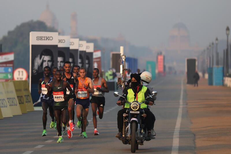 Participants overcame poor air quality during the Delhi Half Marathon on Sunday. AP